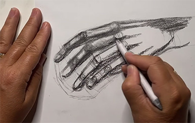 two hands--drawing a hand in charcoal