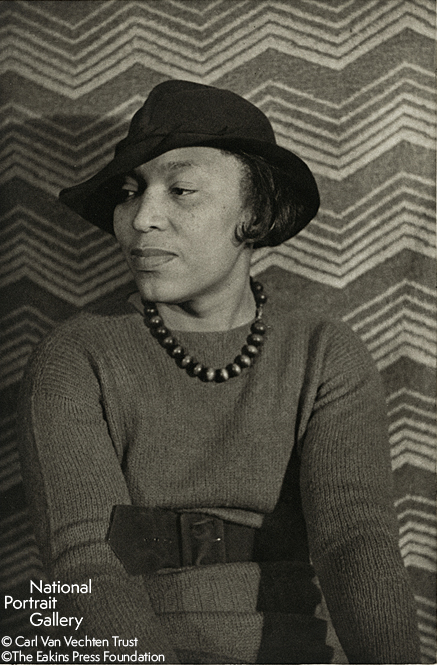 Black and white image of a well-dressed woman looking to the left