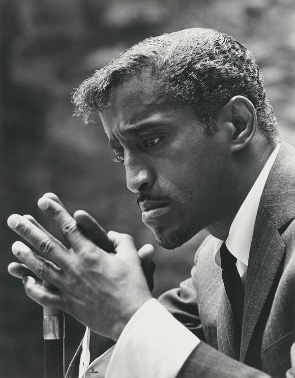 A black and white image of a man looking thoughful
