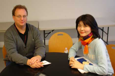 Warren Perry and Saki Tsuiki sitting at a table