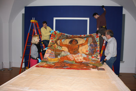 Museum staff putting Mequitta Ahuja's artwork on the wall'