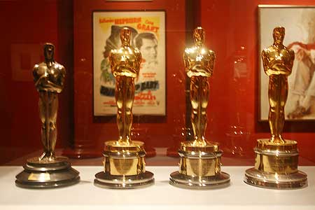 All four of Katharine Hepburn's Oscars, the one on the far left is a darker hue and smaller size