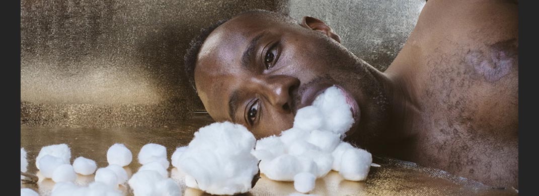 Many lying down with cotton pouring from his mouth