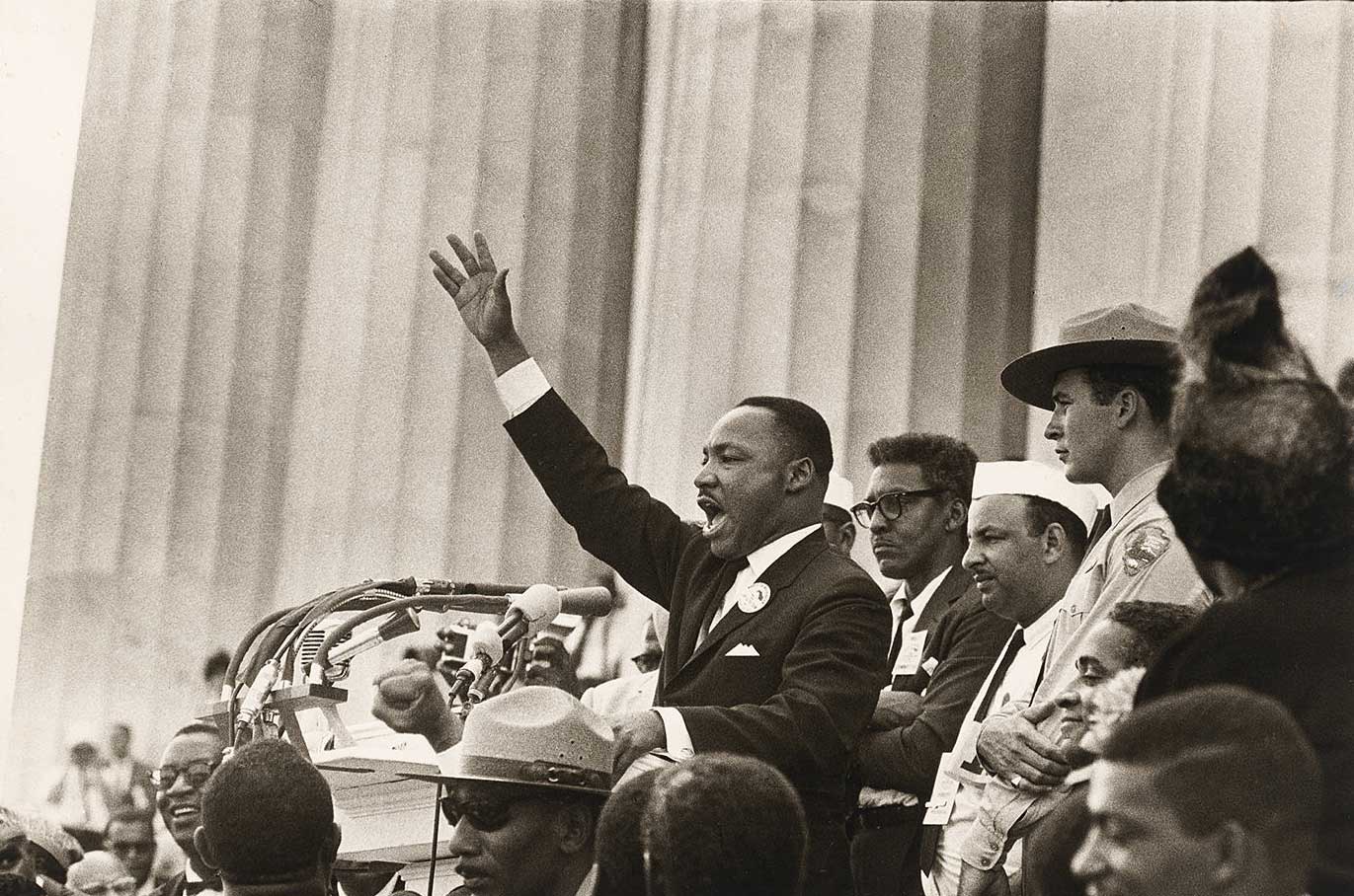 Black and white image of a man speaking passionately on the steps of the Lincoln Memorial