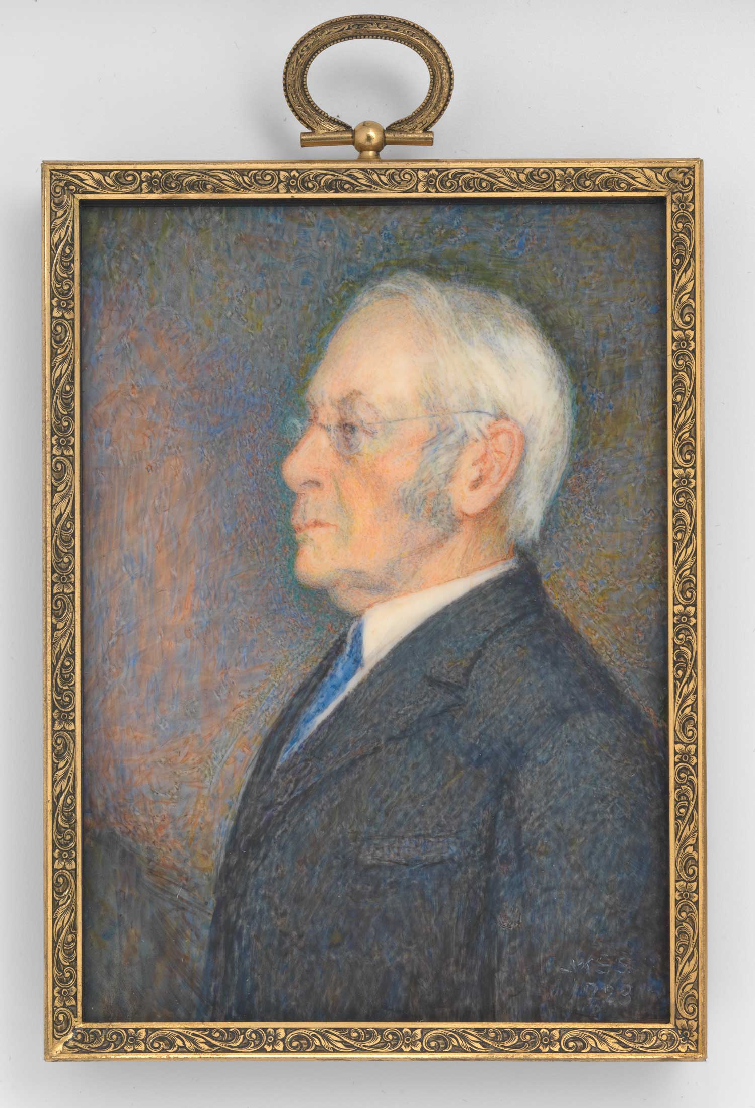 Painted portrait of a man's profile in an ornate gold frame