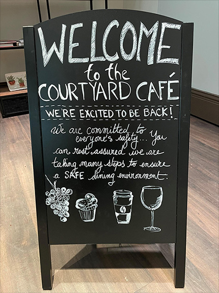 chalkboard welcoming visitors back to the cafe