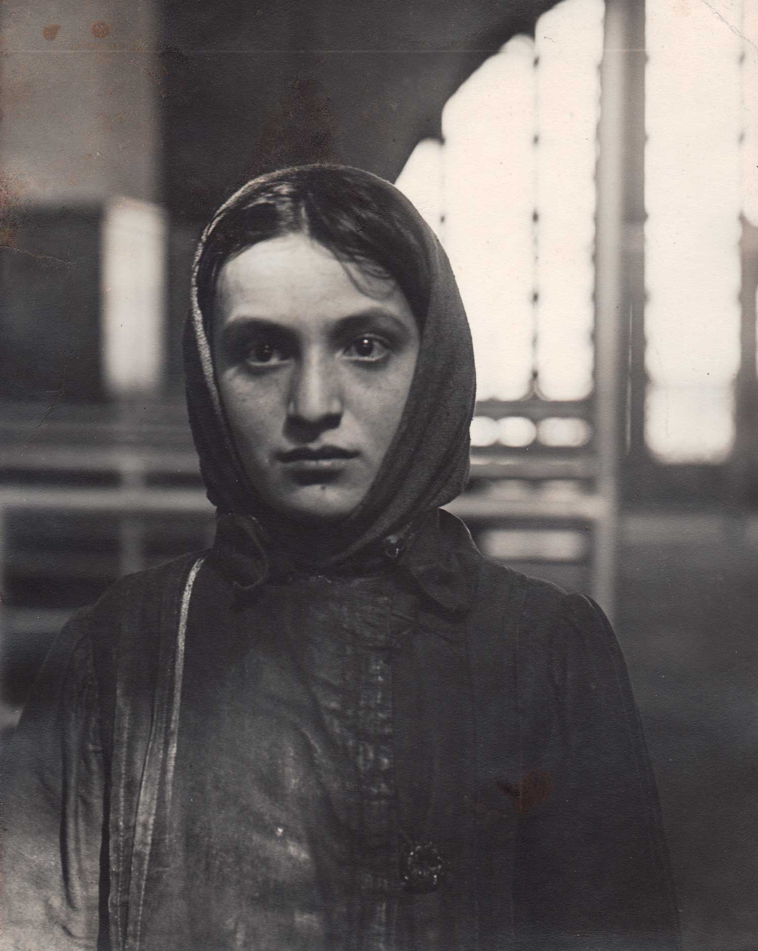 Black and white image of a girl staring blankly at the viewer