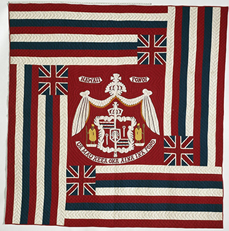 colorful red and white quilt of Hawaiian coat of arms