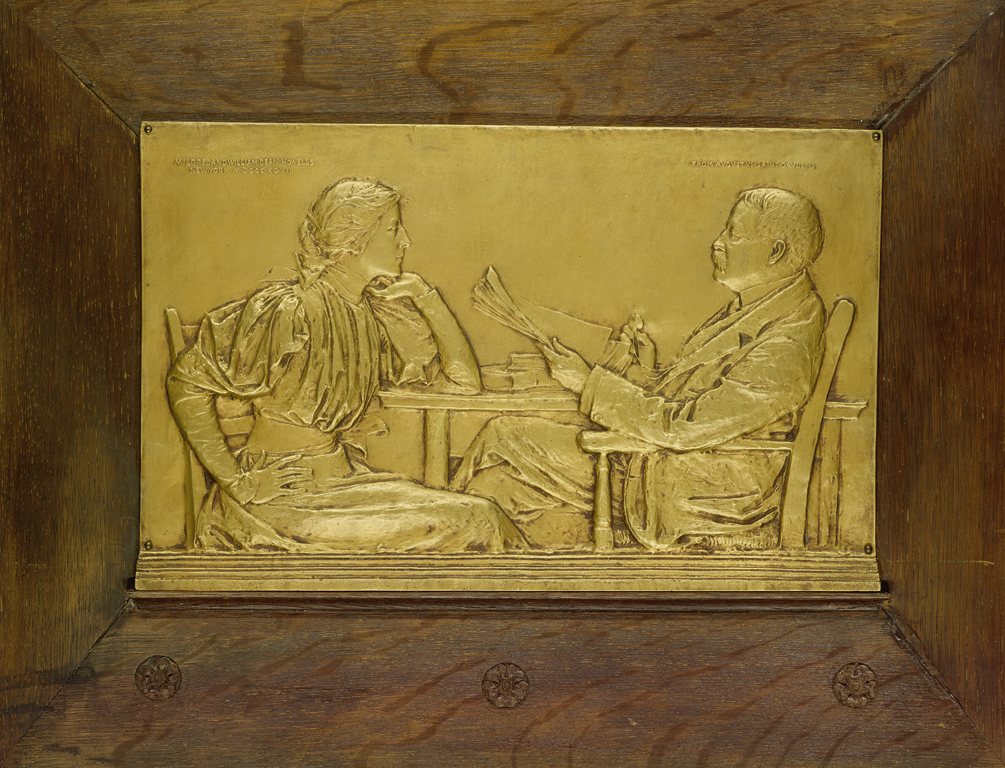 Bas relief of a man and woman reading