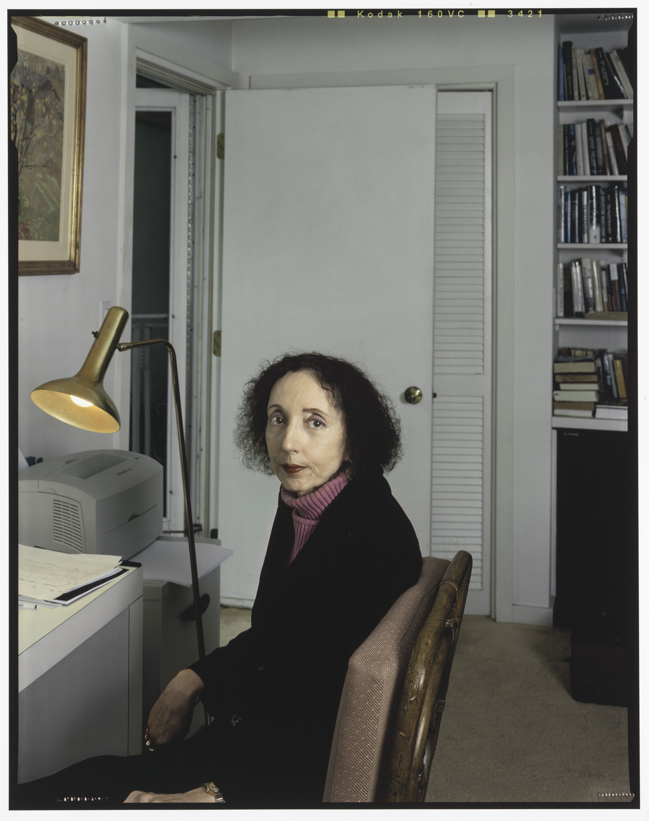 Photograph of a middle aged woman sitting in a study