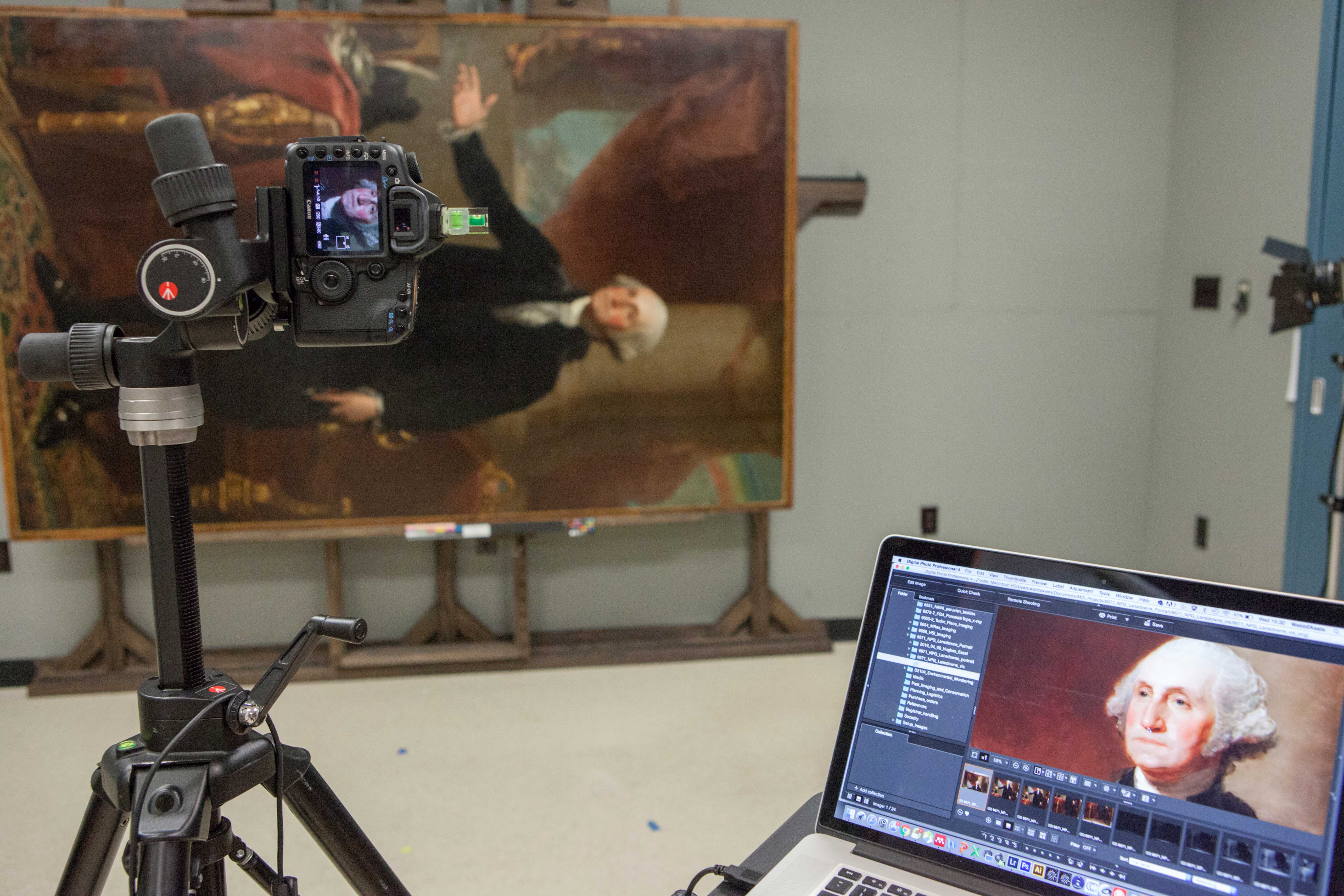 Photograph of a camera and a computer screen showing a picture of George Washington's face