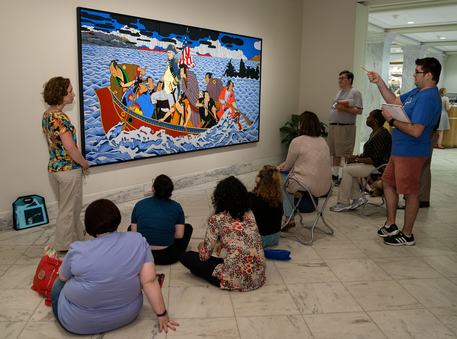 A group of teachers learning about a portrait in the museum