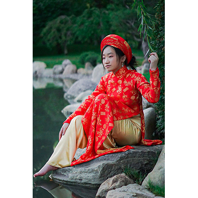 young Asian woman in traditional silk brocade dress