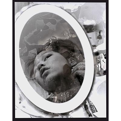 Young woman in a mirror applying makeup