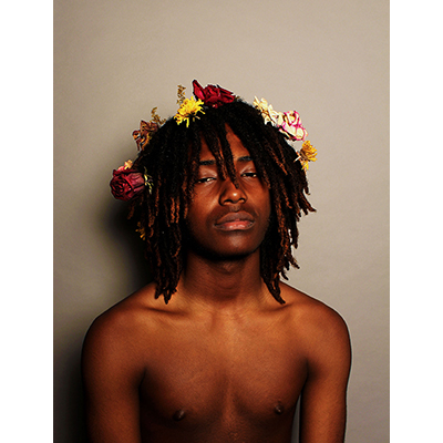 young black man with flowers in his hair