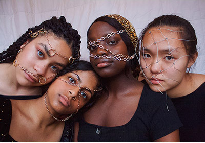 Four Asian girls with jewelry on their faces