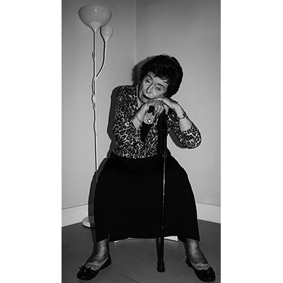 older woman leaning on a cane