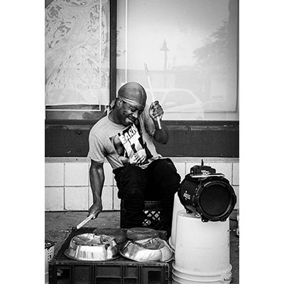 black and white photo of a street musician