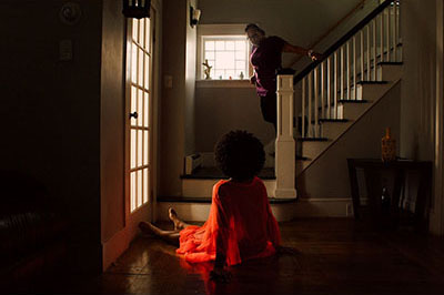 young man sitting at the foot of the stairs