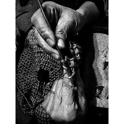 older woman's hands knitting