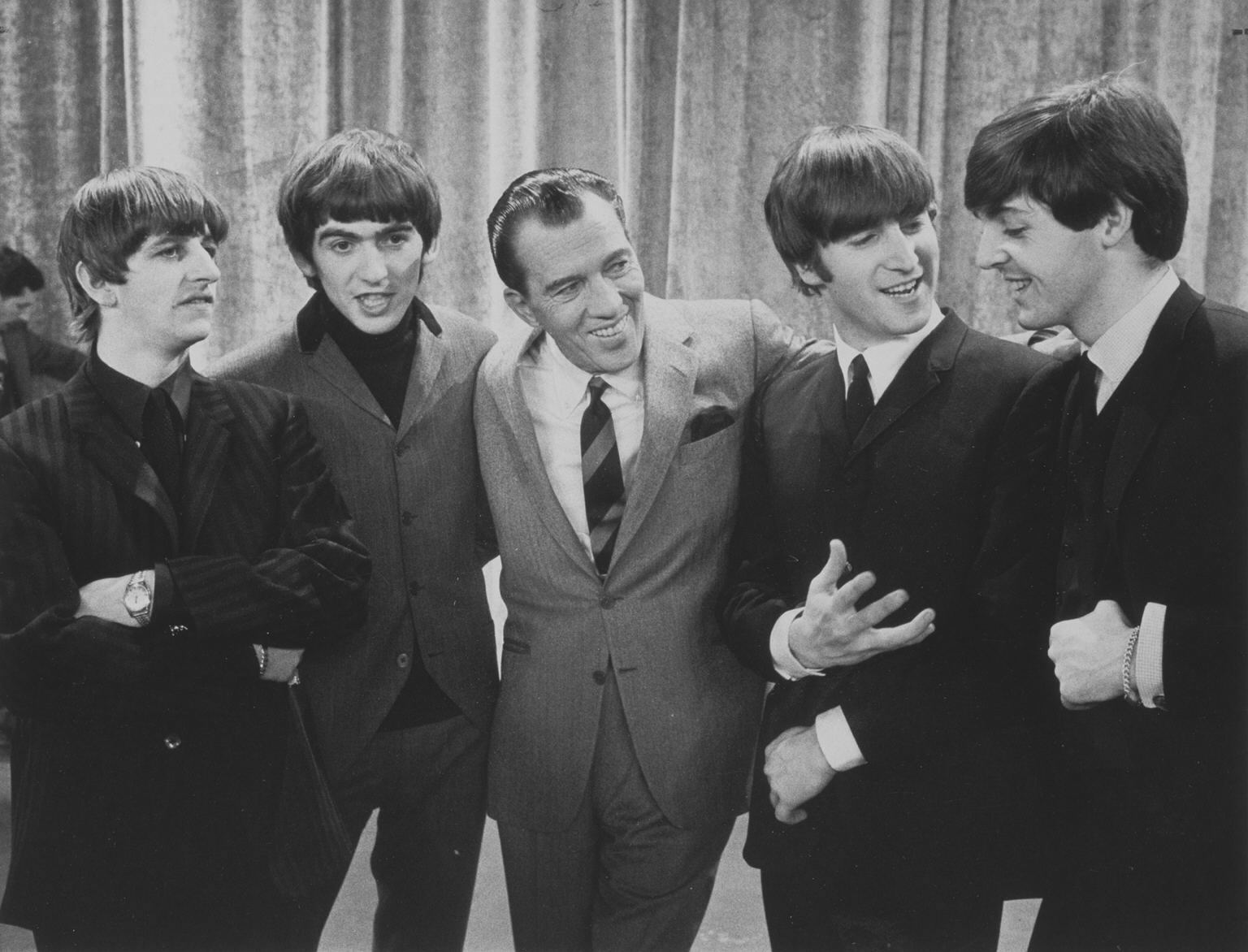 Black and white image of Ed Sullivan and The Beetles