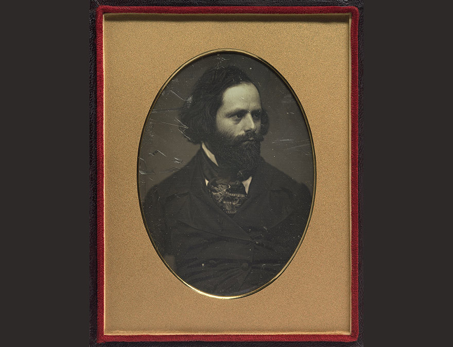 Photo of a bearded man in a gold frame