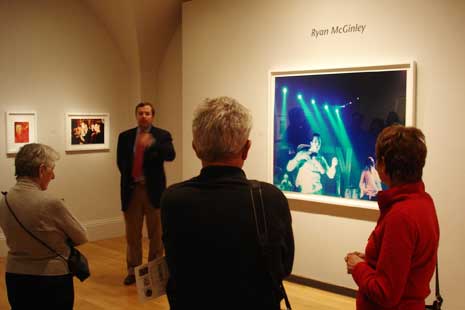 Frank Goodyear at his talk, standing next to Ryan McGinely portrait