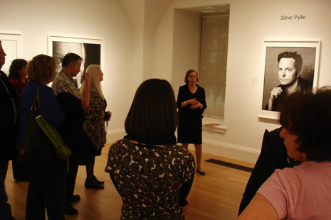 Ann Shumard giving her talk, standing next to Michael J. Fox portrait
