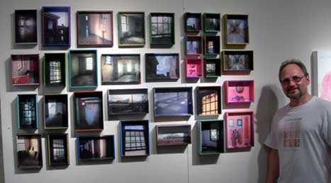 Mark Planisek with his artworks