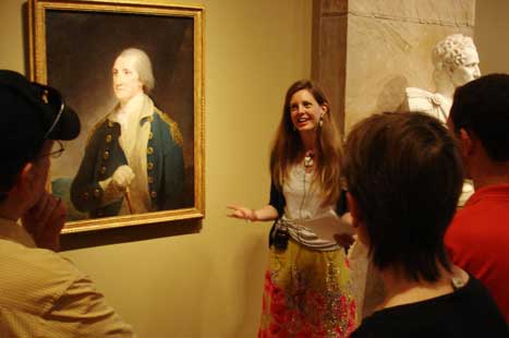 Laura Simo giving talk, next to George Washington portrait