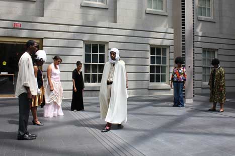 Teen students performing "Portraits Alive!" in museum courtyard