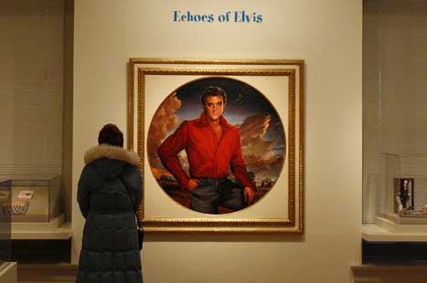 Painted portrait of Elvis Presley, in red shirt and jeans