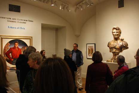 Warren Perry giving talk, standing next to bust of Elvis