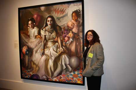 Margaret Bowland standing next to her work in the Portrait Competition exhibition
