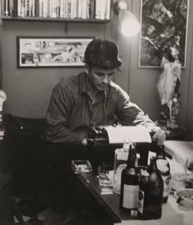 Blog_kerouac Black and white photo of Jack Kerouac at typewriter