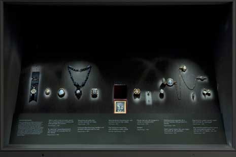 Case from "Tokens of Affection" exhibition, with many small pieces of daguerrean jewelry