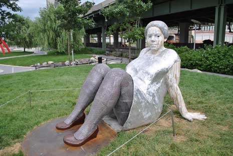 Outdoor sculpture of woman reclining on the ground