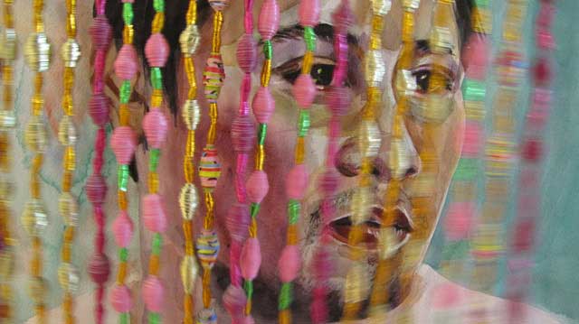 Blog_obpc_levonian_take_picture_w_a_puma Woman's face behind beaded curtains