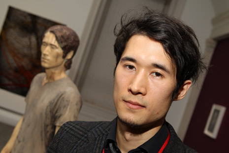 Sequoyah Aono with his sculpture in the background