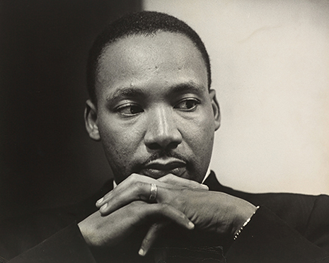 Hiller_full Photograph of Martin Luther King with solemn expression and hands folded underneath his face