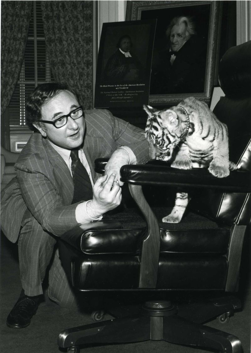 Black and white photo of Marvin Sadik with a baby tiger