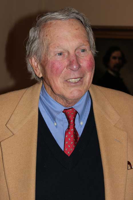 Brooks Robinson in tan suit and red tie