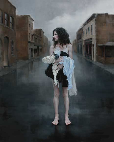 Self portrait of artist standing in middle of street holding her clothes