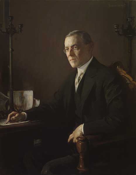 Portrait of Woodrow Wilson, sitting with pen in hand