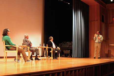 All the speakers on stage, sitting and looking at audience member