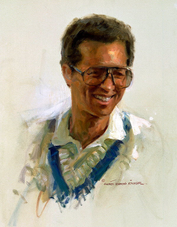 Seated man holding a tennis racket