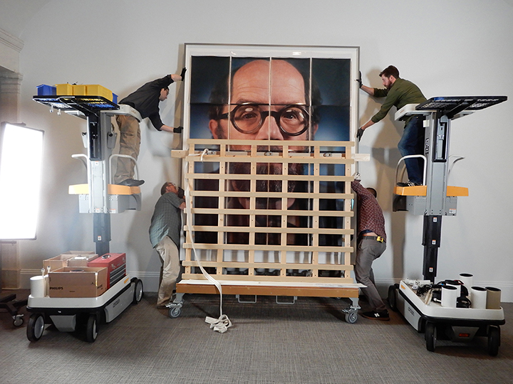 Installation of Chuck Close’s self-portrait 