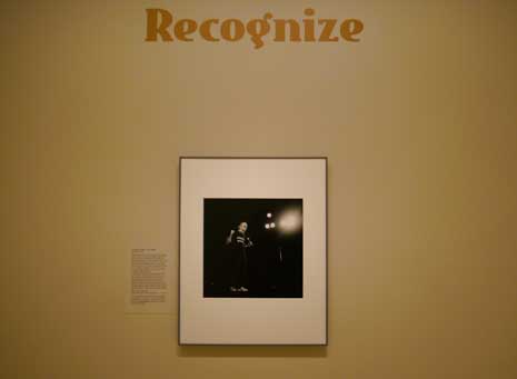 Color photo showing the photo of George Carlin on the "Recognize" wall at the National Portrait Gallery.