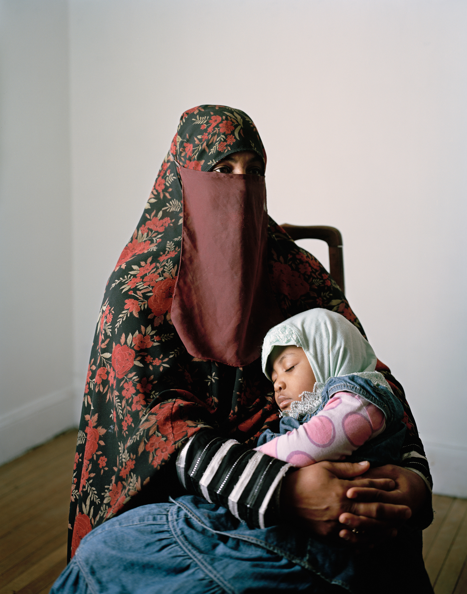 Woman in head covering, with small child