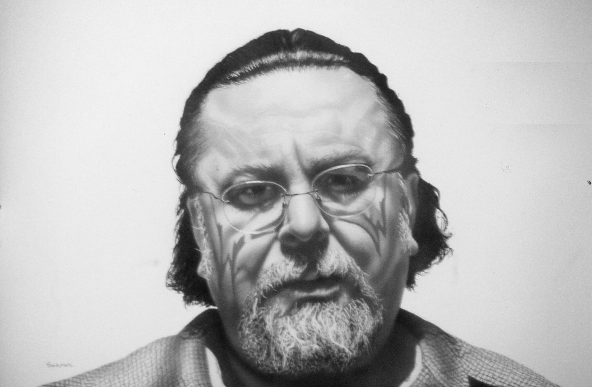 Black and white image of a man looking straight ahead